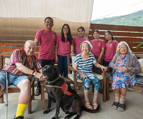 image of residents Valley Comfort Care Home playing with the staff dog.